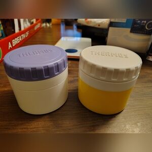 Two vintage Thermos jars with lids